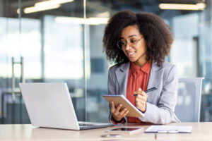 Professional woman taking notes during a business meeting in a modern office