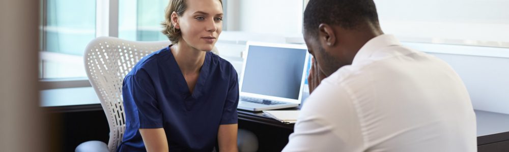 Doctor In Consultation With Depressed Male Patient