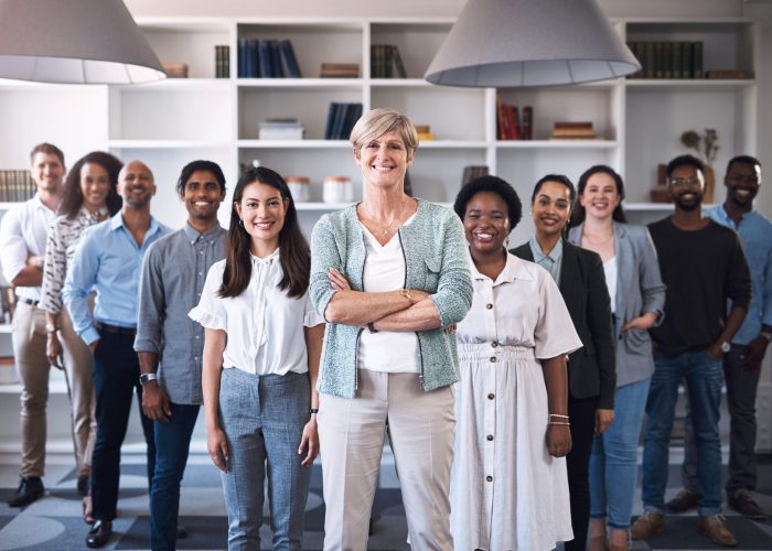 Portrait of a diverse group of businesspeople standing together in an office.